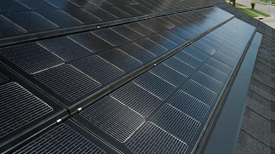 Close-up example of low-profile solar roofing tiles integrated into asphalt roofing